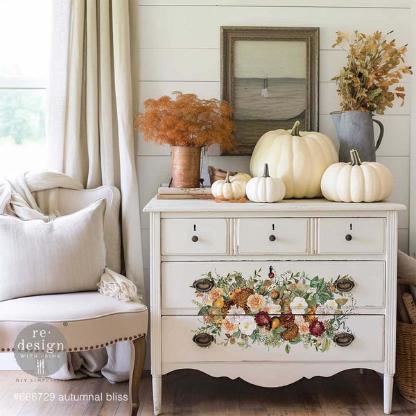 A white vintage dresser features ReDesign with Prima's Autumnal Bliss transfer on its 2 bottom large drawers.