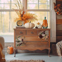 A vintage dresser is painted an orange/brown and features ReDesign with Prima's Prairie House transfer on its drawers.