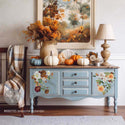 A vintage light blue console table with a natural wood top features ReDesign with Prima's Seasonal Splendor small transfer on its 2 doors.