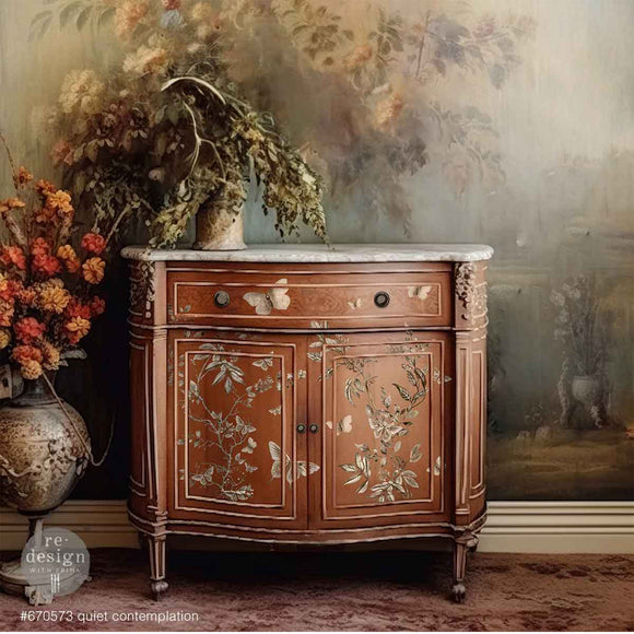A small natural wood buffet cabinet features ReDesign with Prima's Quiet Contemplation middy rub-on transfers on the front.