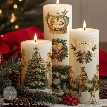 Three lit white candles feature ReDesign with Prima's Sacred Night Collection middy rub-on transfers.