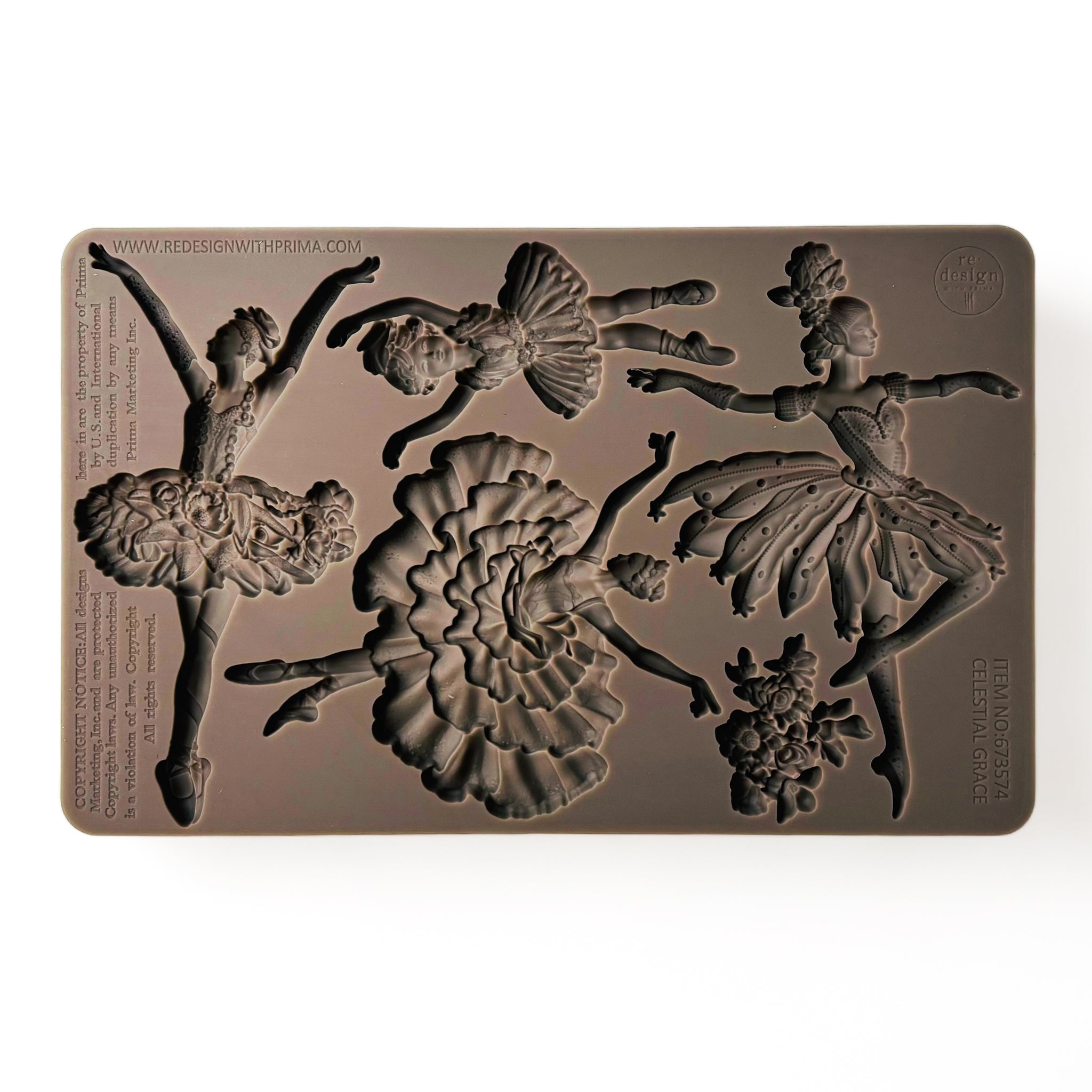 A brown silicone mold of 3 adult ballerinas, a child ballerina, and a bouquet of flowers is against a white background.