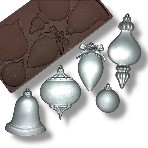mold with Christmas ornament shapes and silver ornaments on a white background
