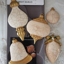 Decorative baubles with cracked texture and gold accents on a gray background