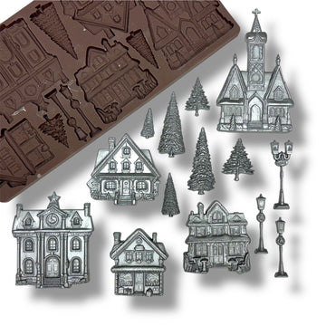 silicone mold with house shapes and silver house decorations on a white background