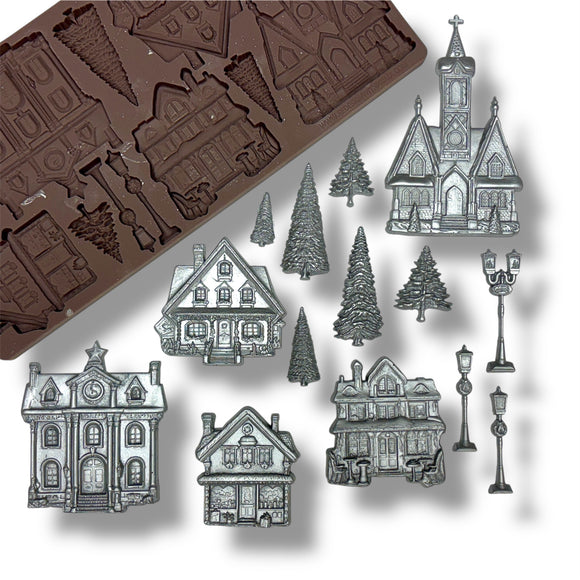 silicone mold with house shapes and silver house decorations on a white background