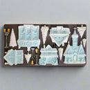 Set of casting molds shaped like houses and trees on a silicone mold.