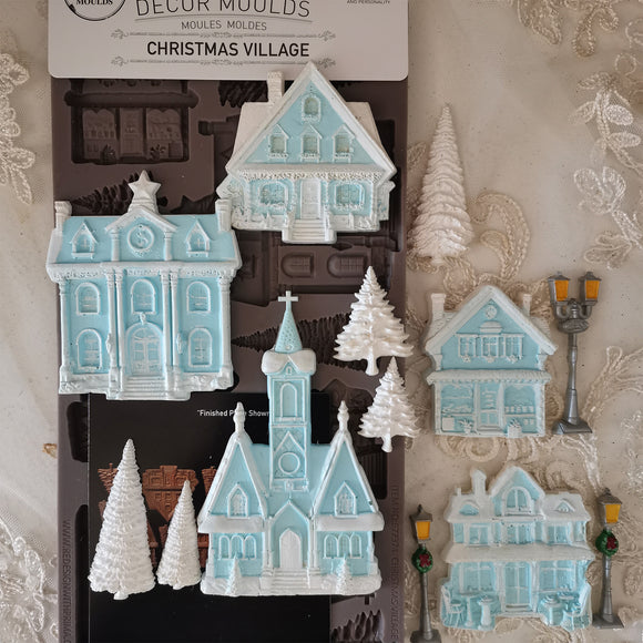 Decorative Christmas village mold set with houses and trees on a decorative background