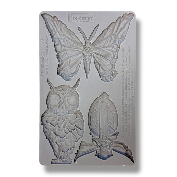 Silicone mold with butterfly, owl, and leaf shapes on a white background