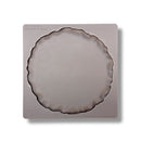 Silicone mold shaped like a pie crust on a white background