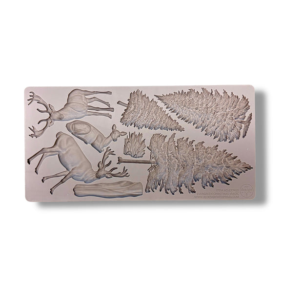 Silicone mold with deer and leaf designs on a light pink background