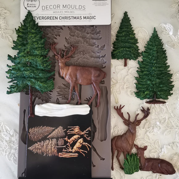 Decorative moulds with trees and deer on a white background
