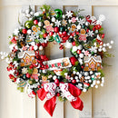 A Christmas wreath created by Casamia is covered in colorful small ornament baubles and features colorful castings from ReDesign with Prima's Festive Gingerbread Treats silicone mold on it.