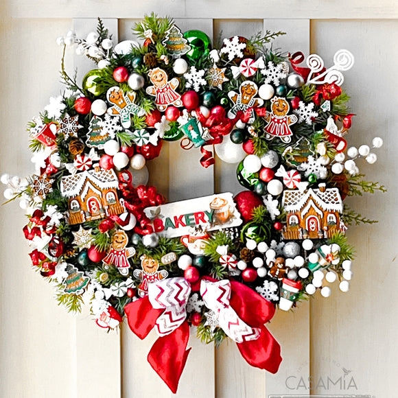 A Christmas wreath created by Casamia is covered in colorful small ornament baubles and features colorful castings from ReDesign with Prima's Festive Gingerbread Treats silicone mold on it.