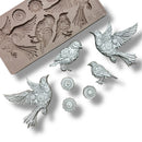 A silicone mold and silver colored castings featuring 4 birds adorned in cogs and gears, along with 3 separate gears are against a white background.