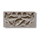 A silicone mold featuring 4 birds adorned in cogs and gears, along with 3 separate gears is against a white background.