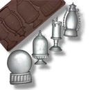 silicone mold with silver castings (candle, lantern) on a white background