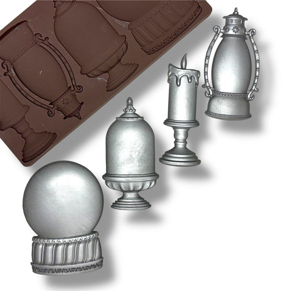 silicone mold with silver castings (candle, lantern) on a white background