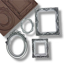 Decorative silver frames next to a silicone mold on a white background