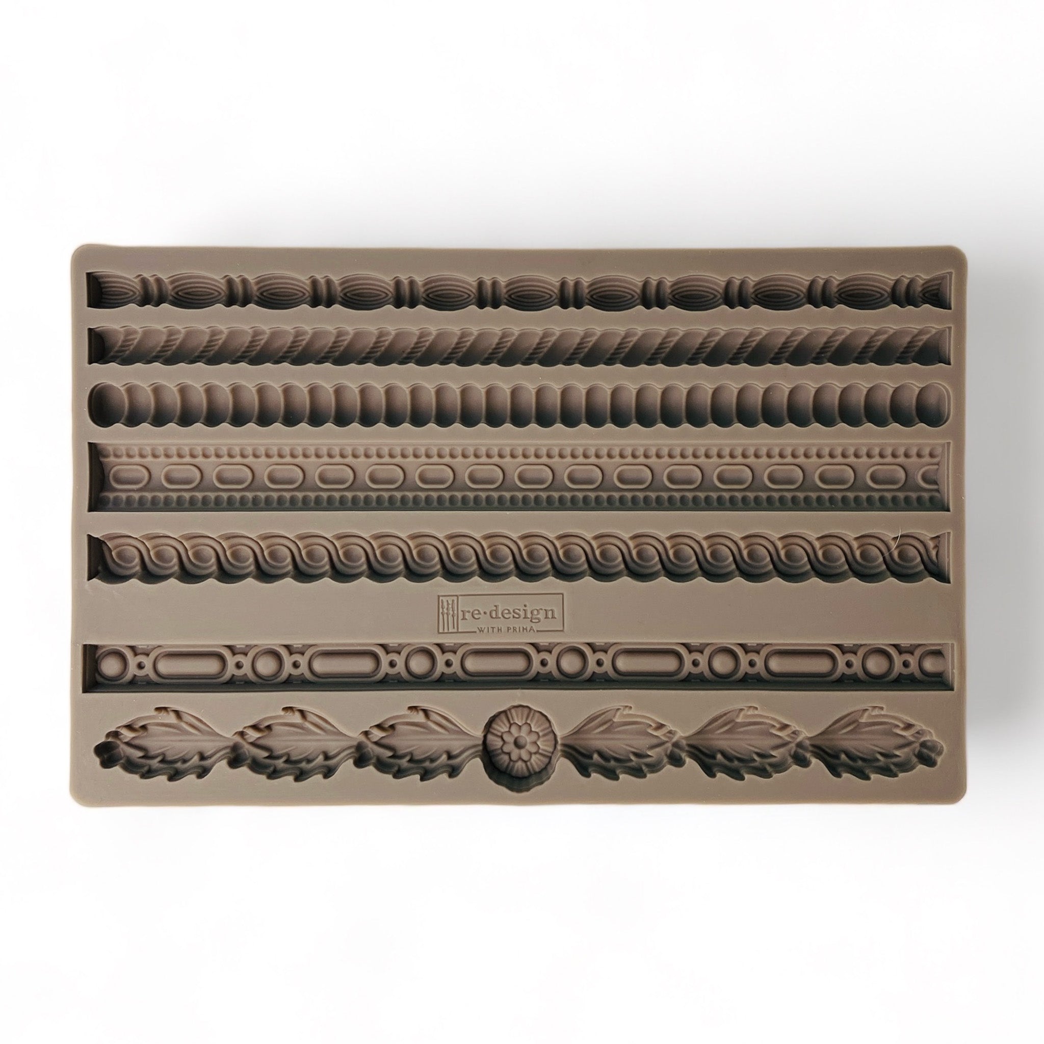 A brown silicone mold that features 7 different ornate regal borders is against a white background.