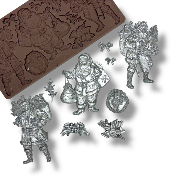 silver Santa Claus castings and silicone mold on a white background