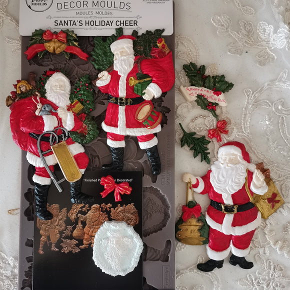 Decorative Santa Claus mold set with packaging on a textured surface