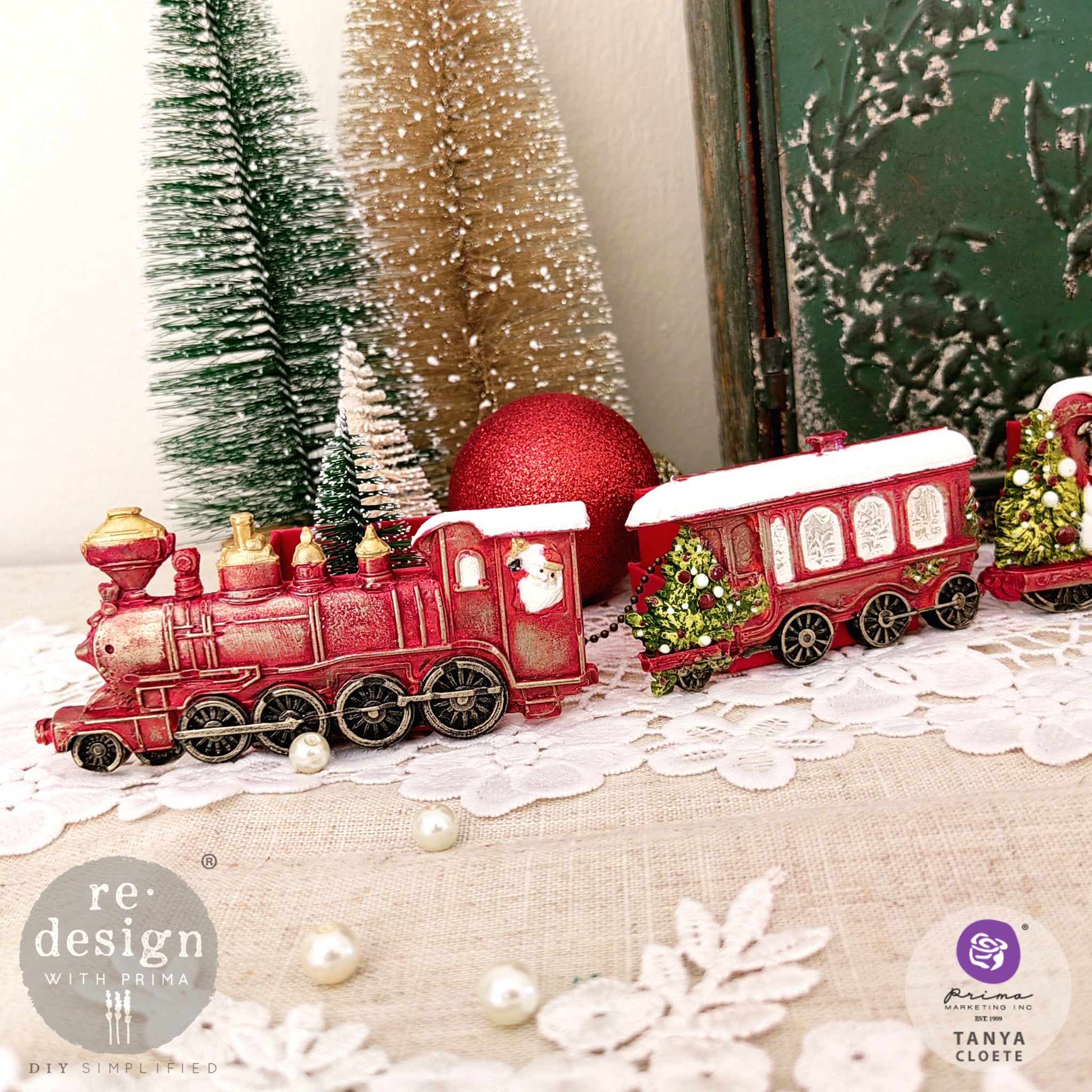 A close-up of colorful castings created by Tanya Coete made from ReDesign with Prima's Jolly Express silicone mold are set up on display with other Christmas items.