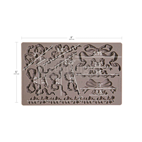 Silicone mold with floral and bow designs and measurements on a white background