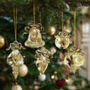 Elegant gold Christmas ornaments with bow toppers hanging on a tree by a fireplace—classic holiday ornament idea for Timeless Ties silicone mold.