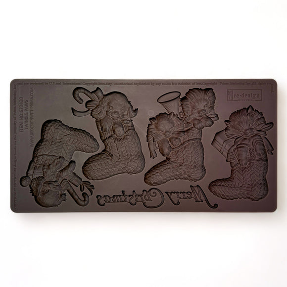 A brown silicone mold featuring 4 Christmas stockings with puppies and kittens in them and the words Merry Christmas is against a white background.
