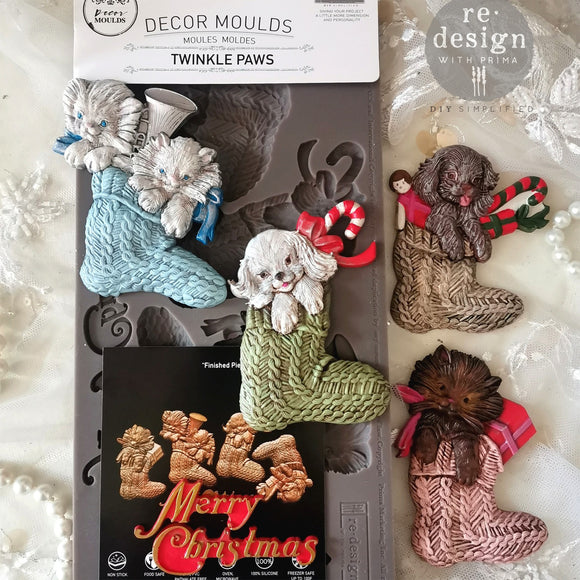 A package of ReDesign with Prima's Festive Cardinal Cheer silicone mold and colorful castings are against a white lace background.