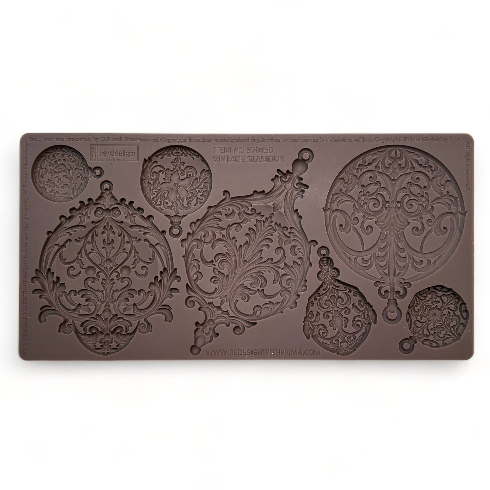 A brown silicone mold featuring 3 large, and 4 small ornate ornaments is against a white background.