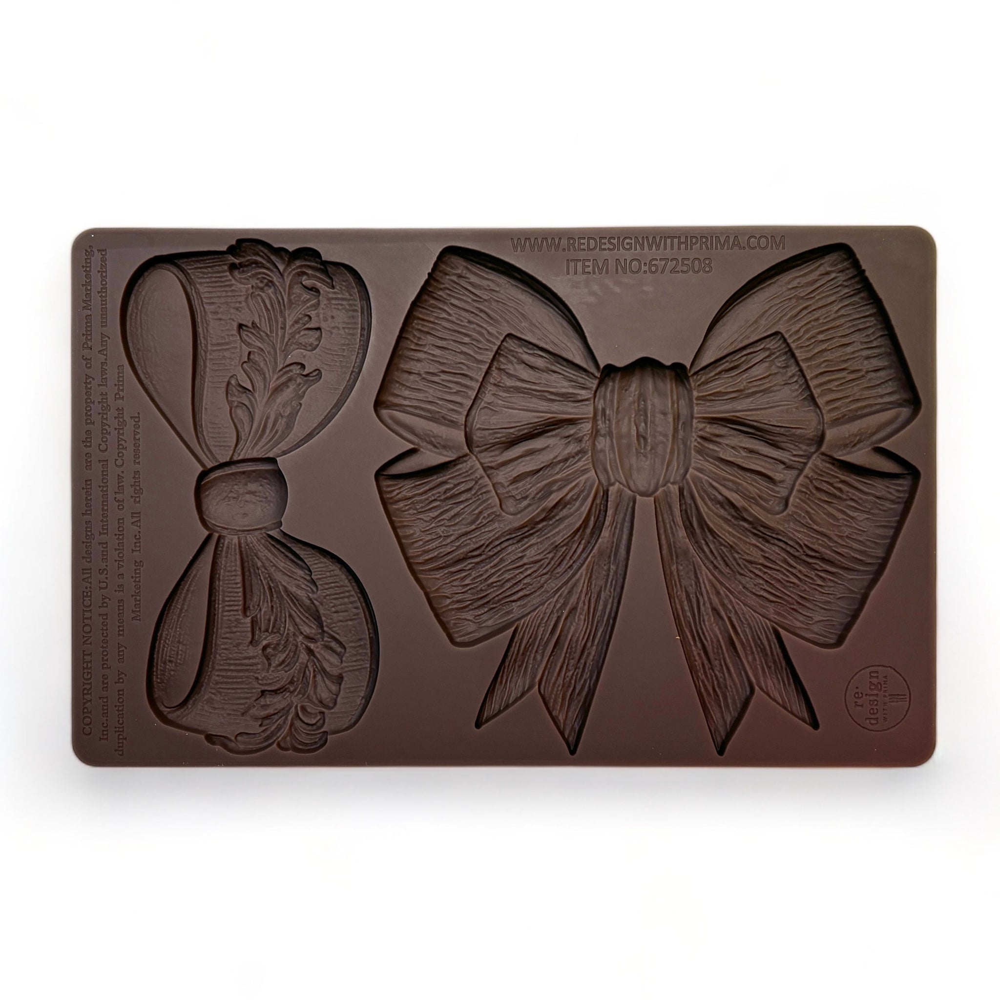 A brown silicone mold featuring 2 different style ribbon bows is against a white background.