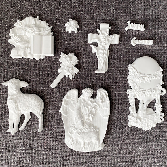 White resin castings from Eternal Spring Faith mold including lamb, angel scene, cross with lilies, floral egg frame, Bible and Joyful Easter words