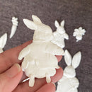 Close-up of ReDesign with Prima Bunny Trail Tales 5x8 silicone mold casting bunny in sweater, shown in hand with carrot and spring accents in background