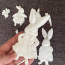 Close-up of ReDesign with Prima Bunny Trail Tales 5x8 silicone mold casting bunny wearing a coat, shown in hand for size and detail
