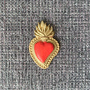 Red and gold sacred heart embellishment made with ReDesign with Prima The Love Edit 5x8 silicone mold on textured fabric