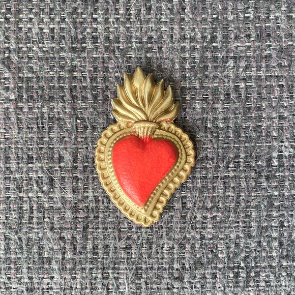 Red and gold sacred heart embellishment made with ReDesign with Prima The Love Edit 5x8 silicone mold on textured fabric