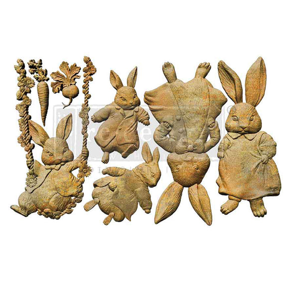 Bunny Trail Tales 5x8 silicone mold castings showing vintage bunnies, swing, carrot, radish, and floral garland embellishments for decor crafts