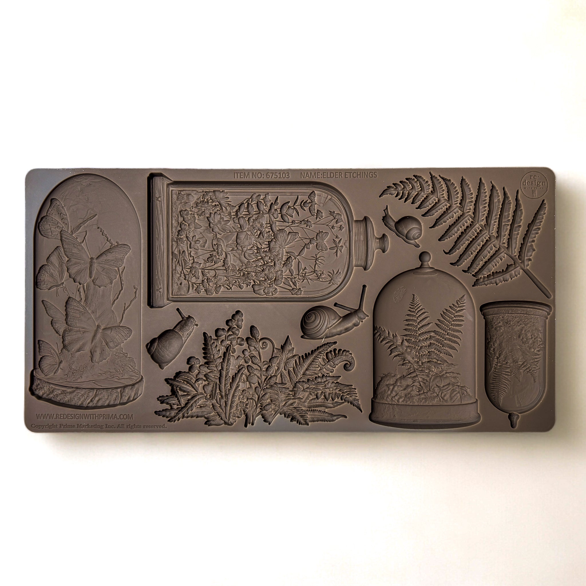 A brown silicone mold featuring 4 Victorian cloches with plants and butterflies in them, and ferns and snails is against a white background.