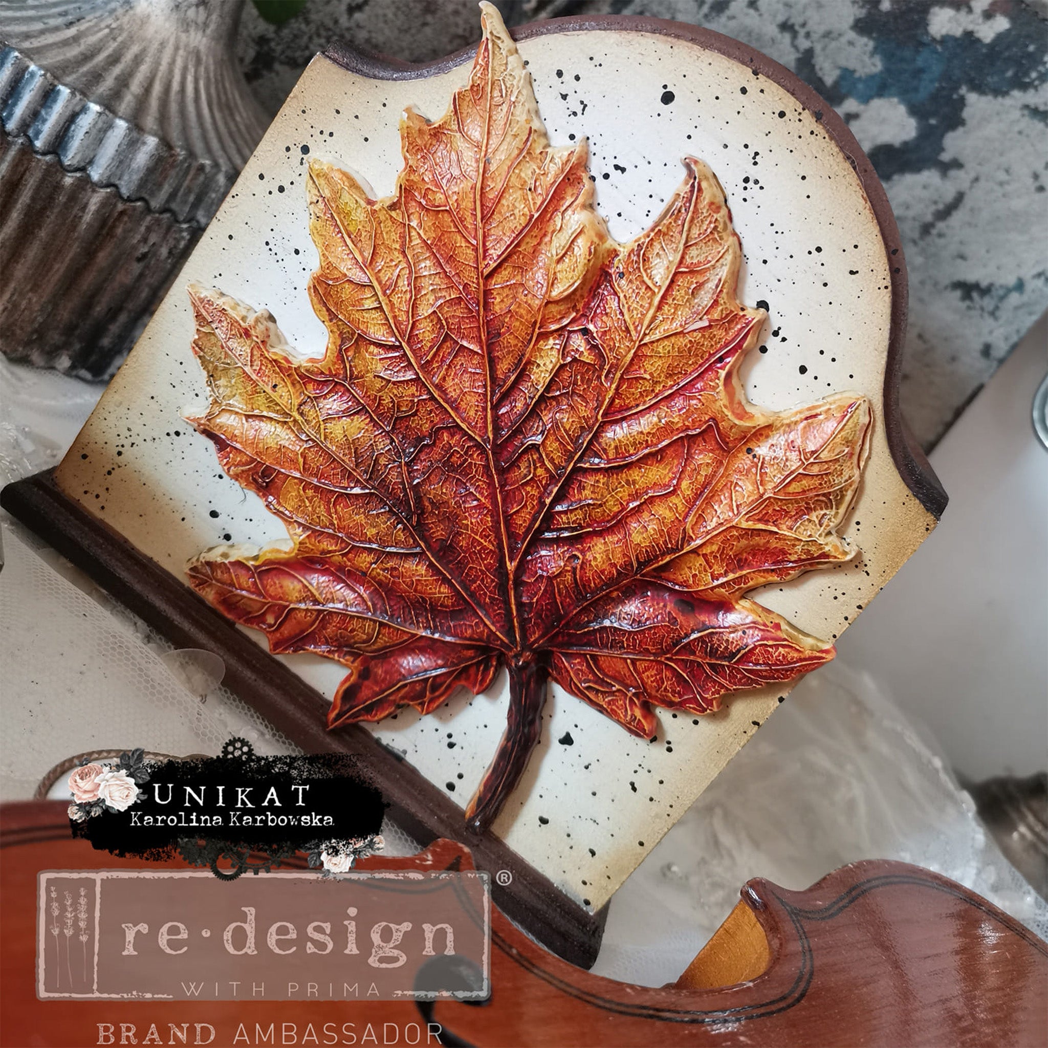 A wood craft created by Unikat Karolina Karbowska features A colorful casting made from ReDesign with Prima's Falling Leaves Fantasy silicone mold.