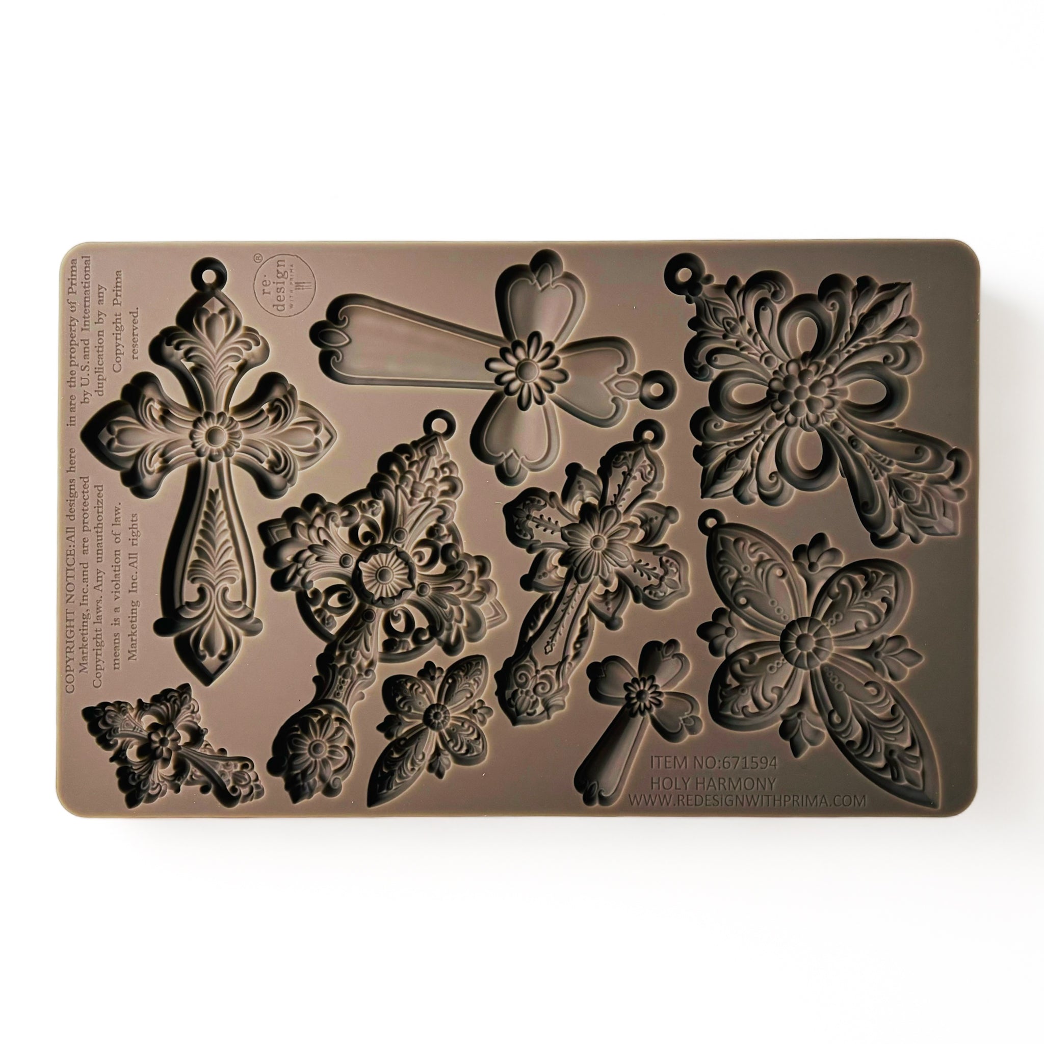 A brown silicone mold of 9 varying sizes of ornate vintage crosses is against a white background.