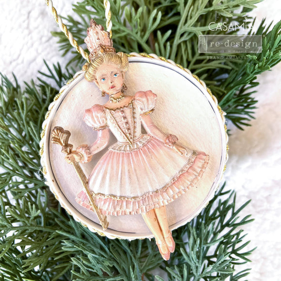 A round flat ornament created by Casamia features a painted casting of a ballerina from ReDesign with Prima's Nutcracker Party silicone mold.