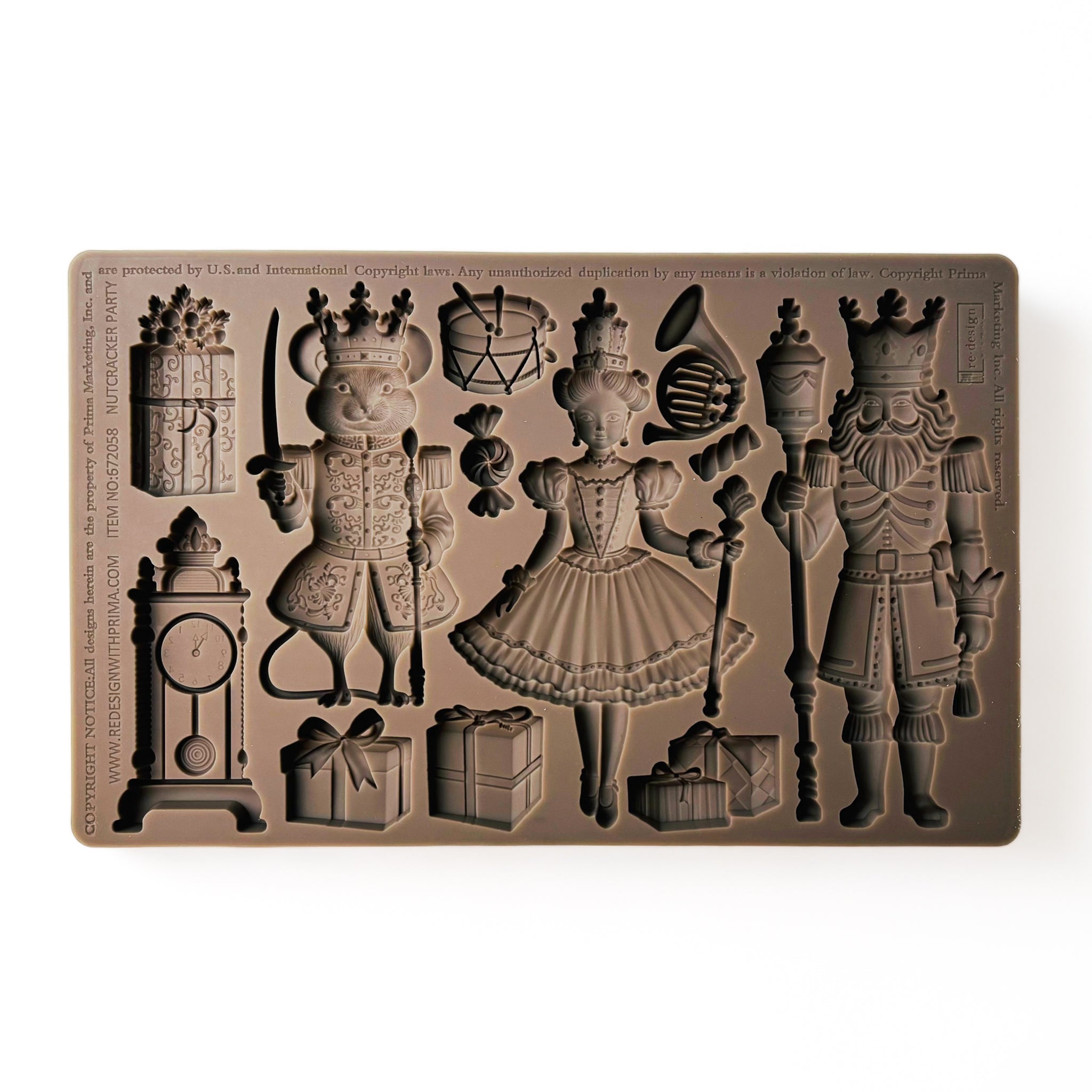 A brown silicone mold of pieces and characters from The Nutcracker is against a white background.