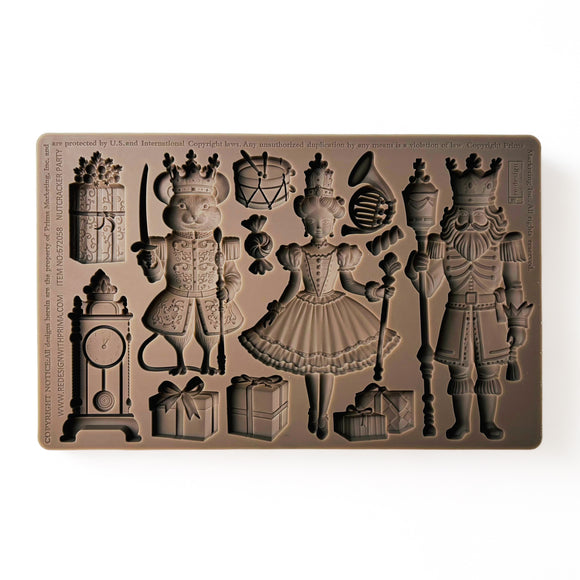 A brown silicone mold of pieces and characters from The Nutcracker is against a white background.