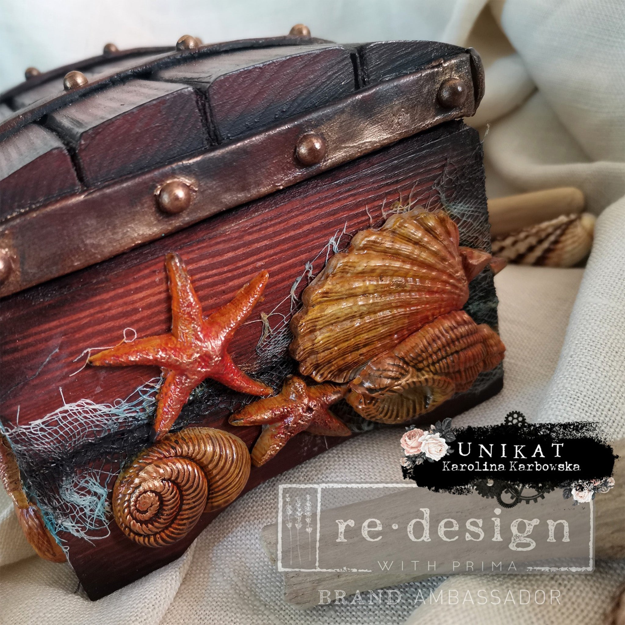 A small wood chest created by Unikat Karolina Karbowska is stained dark colors and features colored castings from ReDesign with Prima's Reef Elegance silicone mold. 