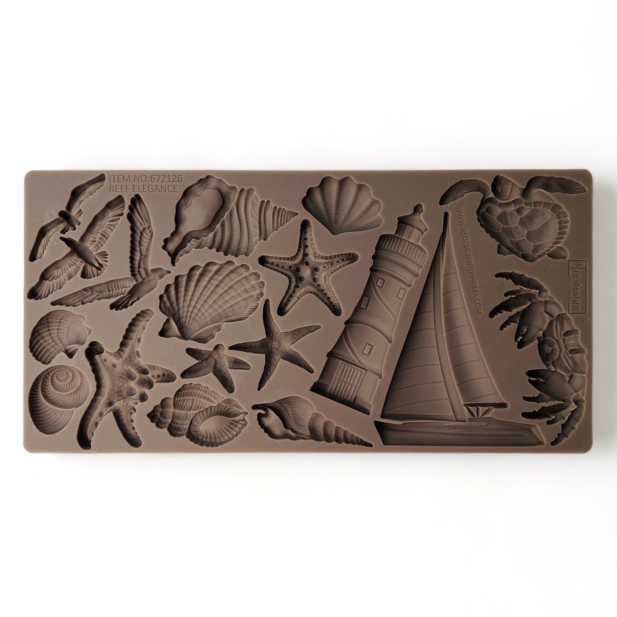 A brown silicone mold that features sailboats, sea shells, star fish, lighthouses, and more is against a white background.