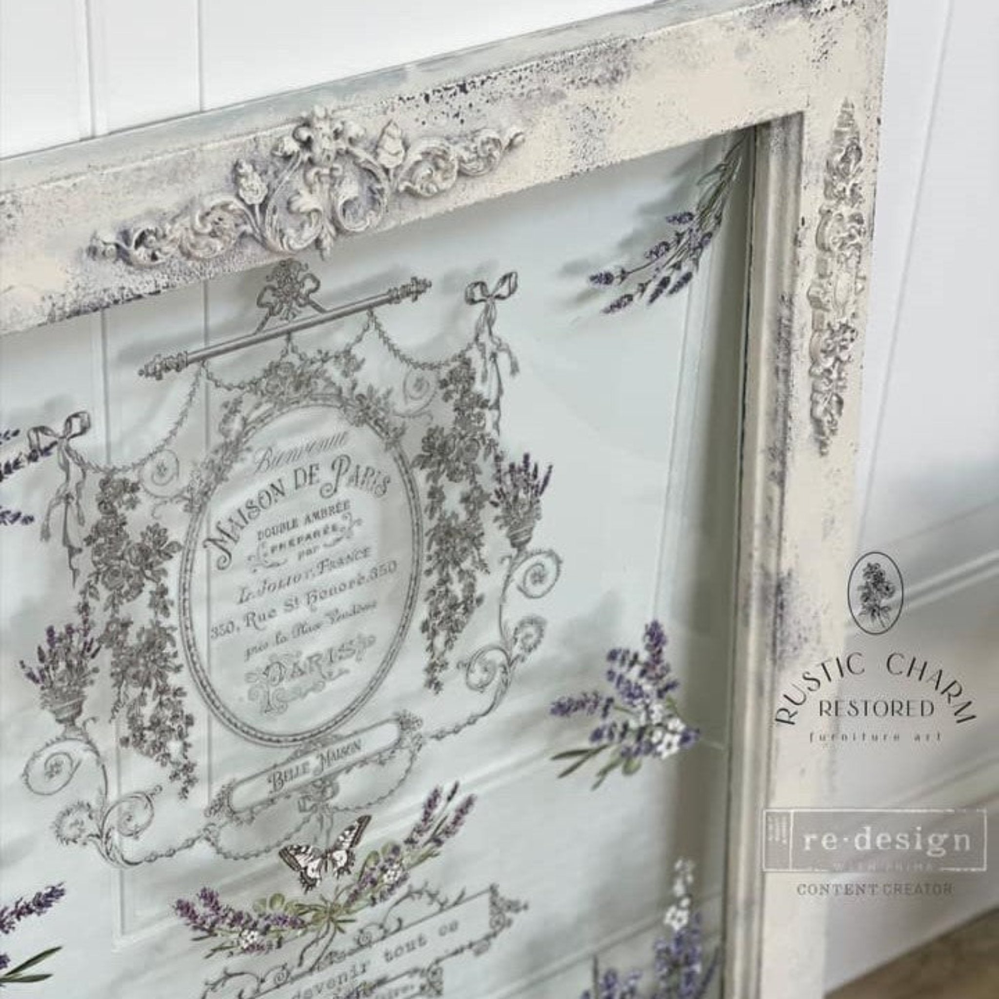 A vintage window refurbished by Rustic Charm Restored is painted soft white and features a casting made from ReDesign with Prima's Remi silicone mold on the top border.