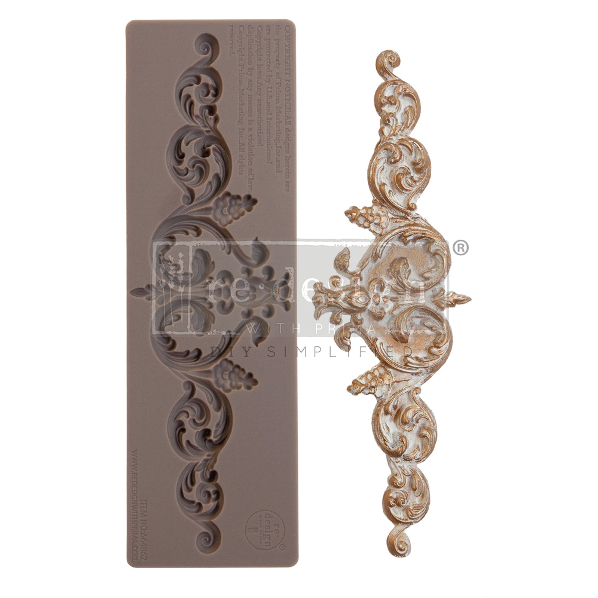 A brown silicone mould and a gold and white colored casting of an ornate scroll plate.