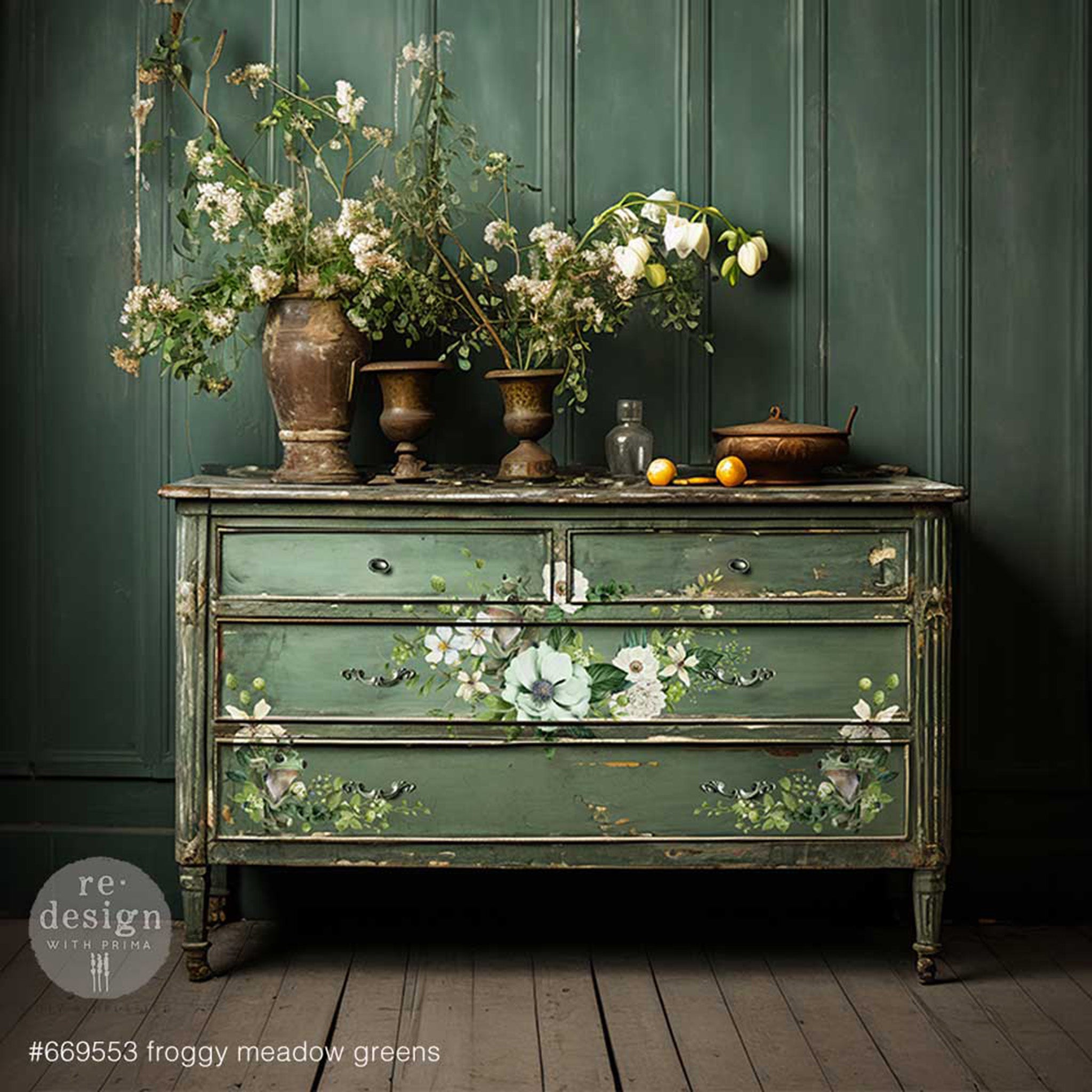 A vintage 4-drawer dresser is painted green and features ReDesign with Prima's Froggy Meadow Greens small rub on transfer on its drawers.